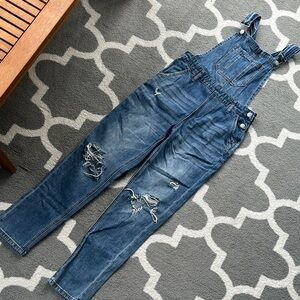 Blue Denim Overalls with Adjustable Straps and Distressed Details